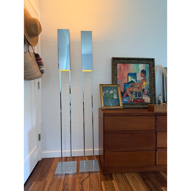 An iconic pair of Robert Sonneman for George Kovacs floor lamps that perfectly captures the sleek sophistication of late...