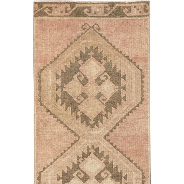 This mid-20th-century Turkish Anatolian long runner presents a commanding procession of ten linked hexagonal medallions...