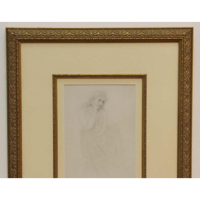 Academic manner pencil drawing on paper of a seated pensive woman. The drawing is left unsigned. The piece is framed in a...