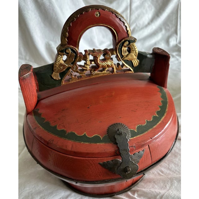 Similar wooden baskets with ornamental gold handles are being sold as a set. The large basket is round and measures 13”...