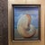 Post modern surrealist style oil painting of a shell set against an ocean scene.