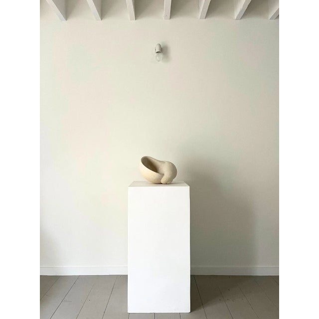 A large sculptural shell formed by hand from a single block of solid stone. This beautiful and tactile work has been...