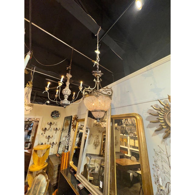 The Late 19th c. French Louis XV Bronze and Crystal Chandelier is a luxurious and elegant lighting fixture that adds a...