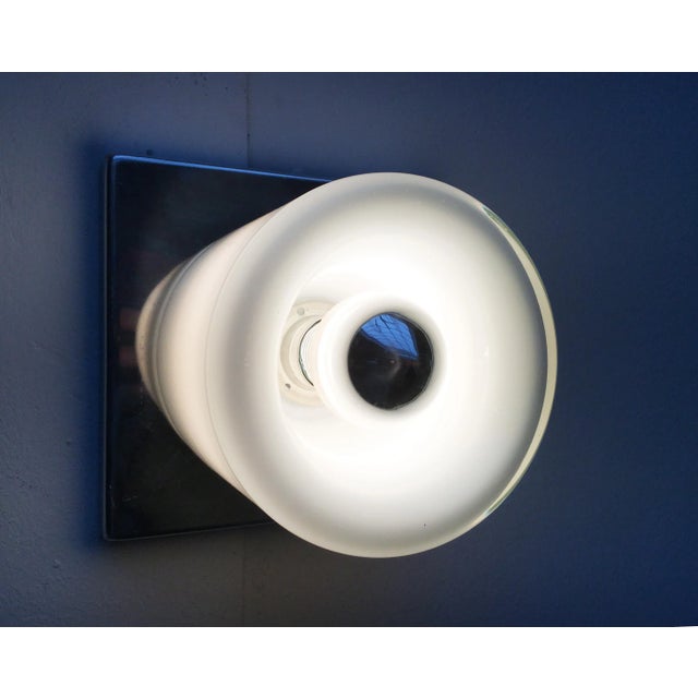 Imposing Space Age wall lamp from the renowned manufacturer Doria Leuchten. On a square chrome wall plate sits a...