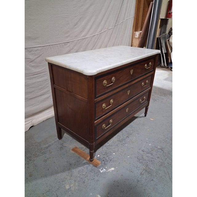 An elegant French Directoire walnut commode dating to the transitional period between the late 18th and early 19th...