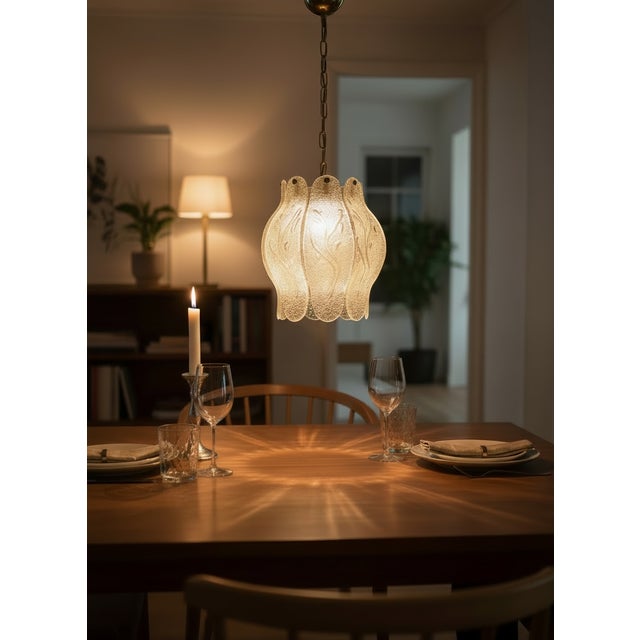 A vintage Italian pendant light dating from the 1970s, featuring a sculptural shade composed of multiple hand-blown Murano...