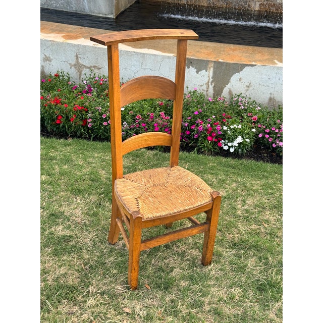 19th-century French prie-dieu or prayer chair, constructed from beech wood with a hand-woven rush seat. Features a tall,...