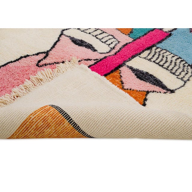 Bold and vibrant, this hand-knotted wool rug features abstract shapes in Fuchsia Pink, Teal Blue, Tangerine Orange, and...