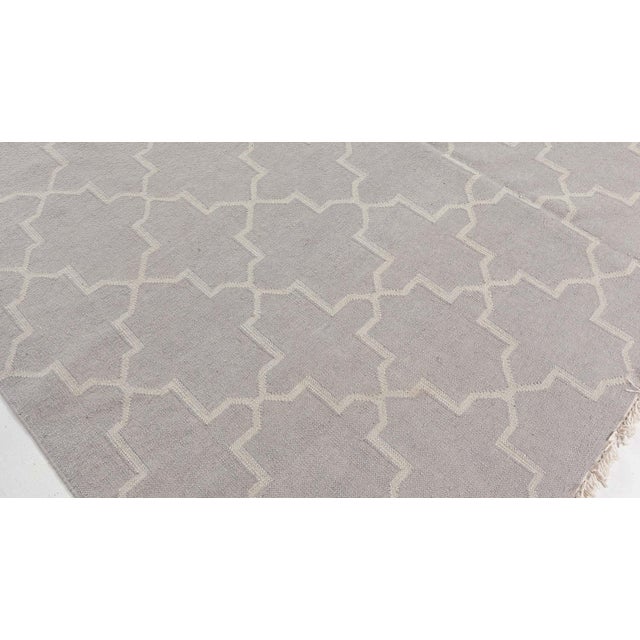 This antique Indian Dhurrie rug, dating back to the 1920s, presents a masterful blend of geometric symmetry and soft-toned...