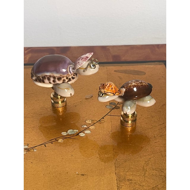 Super cute pair of sea Shell turtles figurines mounted on brass bases as lamp finials.