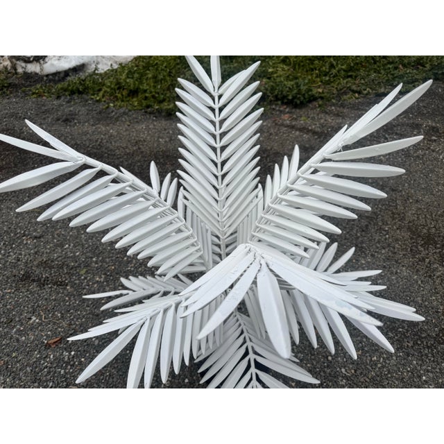 A wonderful tole metal palm plant in white. Newly painted, the circular base is in high gloss black. Would look great...