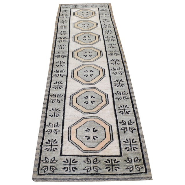 Hand-knotted with care using traditional rug making techniques, this wool rug blends timeless craftsmanship with a modern...