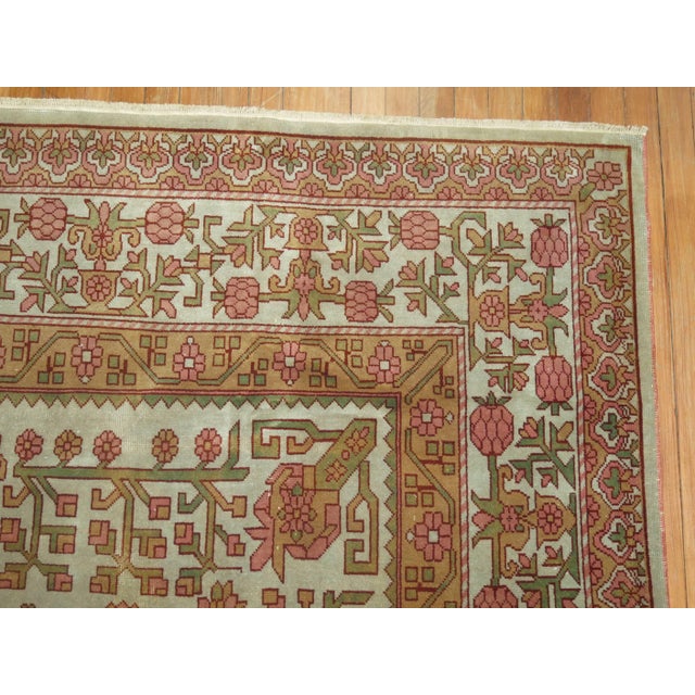Rare size east Turkestan rug from the middle of the 20th century. The field is gray, accents in pink, copper and green....