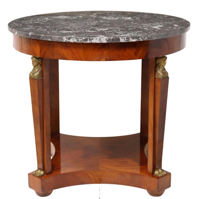 French Empire style flamed mahogany table, early 20th c., having circular marble top, rising on squared and tapered...