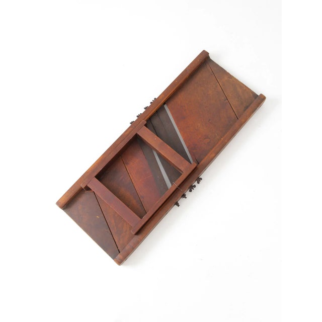 Antique kitchen mandolin slicer with a primitive, rustic appeal. This large hand-operated slicer features a wooden frame...