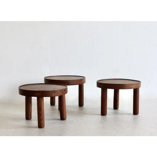 A rare set of three small round tables with a Japanese spirit. A thick circular solid ash top and three cylindrical legs...