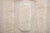 Textured hand-knotted wool rug in Coconut Milk, featuring a structured arrangement of raised rectangular forms. Its...