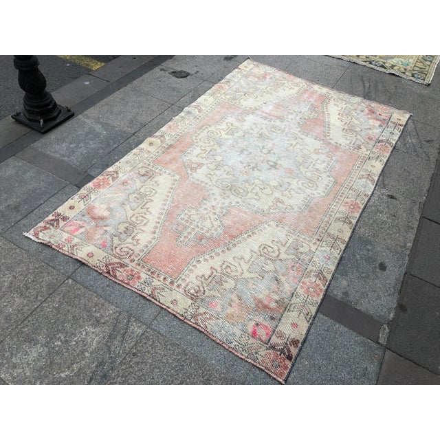 This is a vintage Turkish Oushak rug from the 1960s. The piece was hand-knotted.