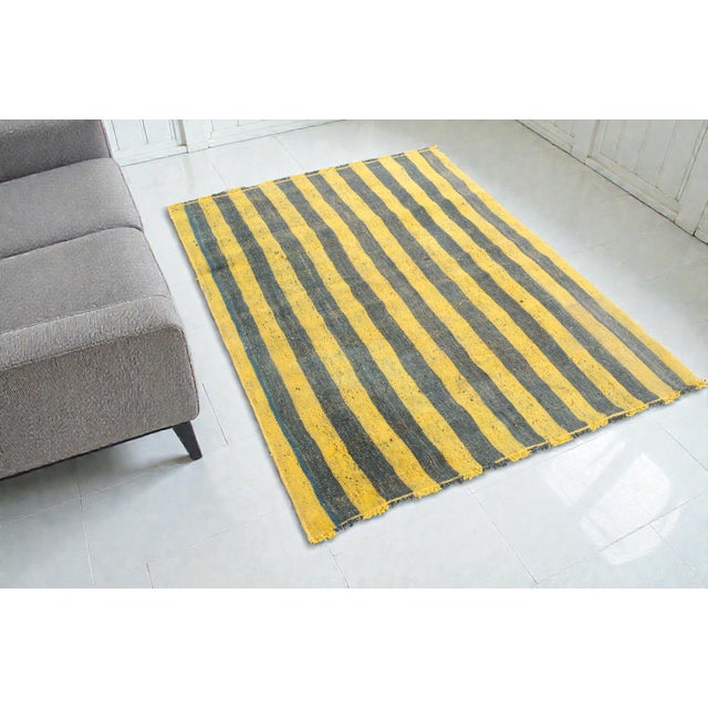 This is a vintage Turkish Oushak rug from the Mid 20th Century. The piece was hand-knotted.