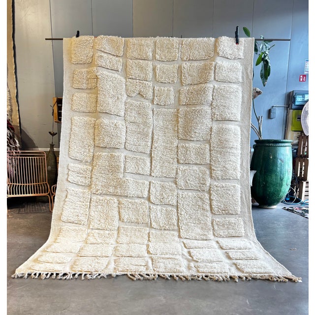 This authentic Moroccan Beni Ouarain rug is a handwoven piece crafted from natural sheep wool, showcasing a refined...