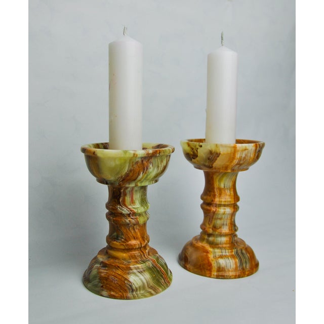 Very nice pair of onyx and brass candlesticks designated and produced in Italy in the 1980s. These candlesticks retain...
