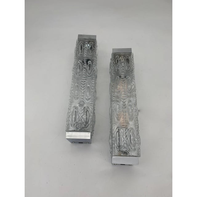 Pair of glass wall lamps and chromed plastic base. They are warehouse funds; never used. Inside there are 2 lamp holders...