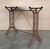 Coffee table with marble top. Item features impressive cast iron construction, two pedestal legs, fancy scroll work to...