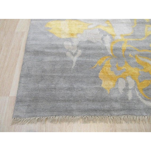 This gray area rug is a hand-knotted pile floor covering crafted from a premium blend of wool and viscose. Made in India,...