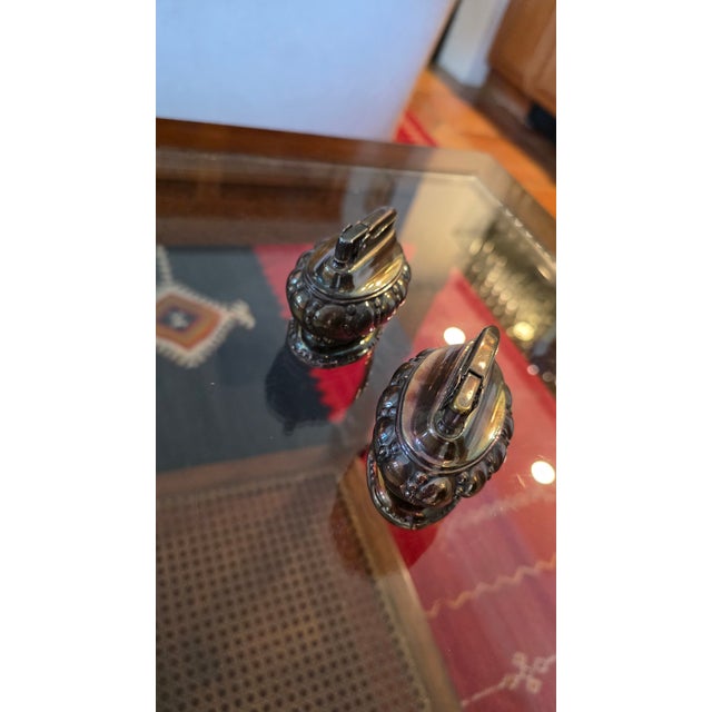 Pair of Mid-Century Ronson "Crown" Silver-plated Table Lighters. Period: 1940s to 1950s. American Heritage: Ronson was...