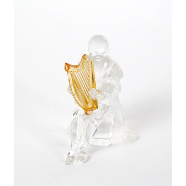 An elegant decorative sculpture by Saint-Louis, the renowned French crystal manufacturer, depicting a seated female figure...