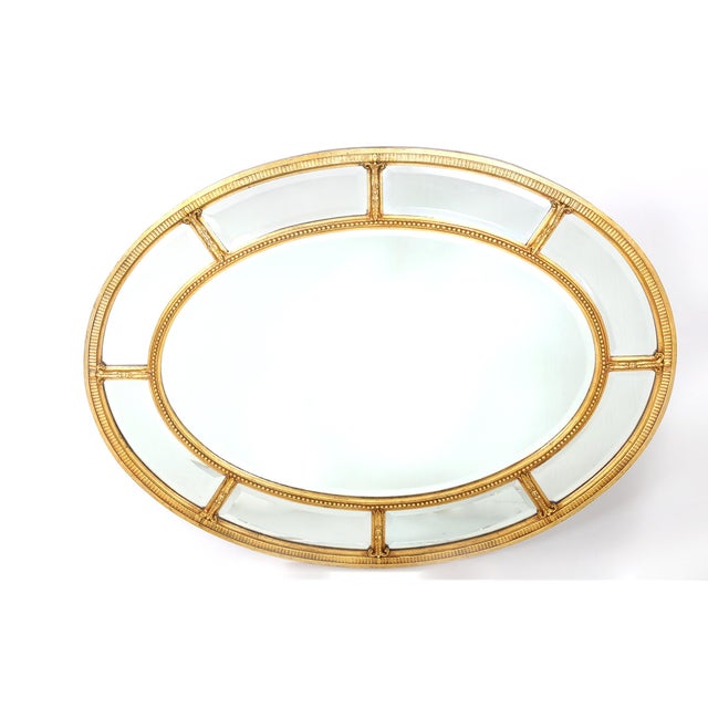 Gilt wood framed oval shape beveled hanging wall mirror. The mirror can be hanged horizontally / Vertically. Minor wear...