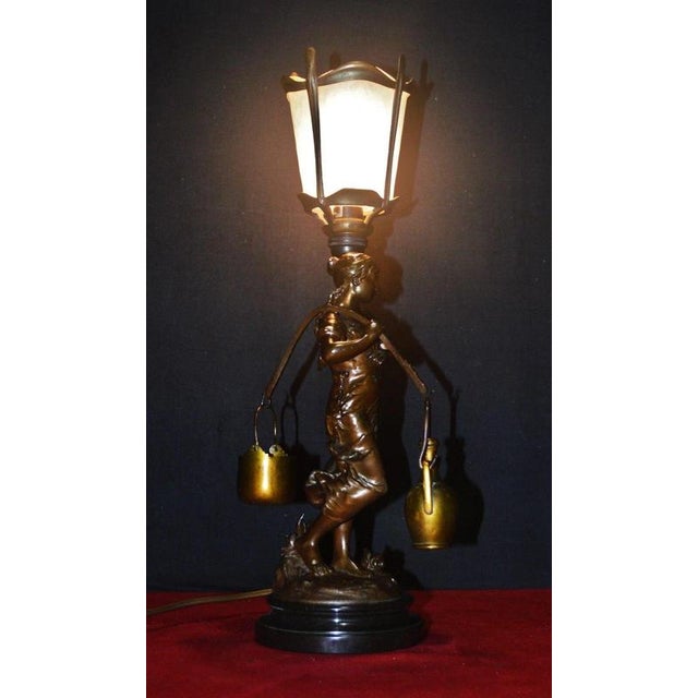 A highly decorative late 19th-century Art Nouveau bronze figural table lamp attributed to Luca Madrassi, circa 1890,...