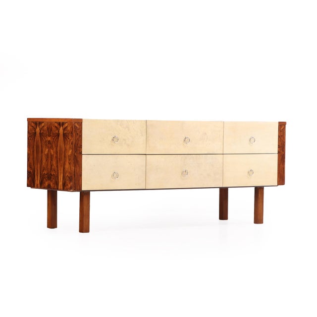 A striking and sculptural six-drawer dresser or credenza combining the refined geometry of late Art Deco with the rich...