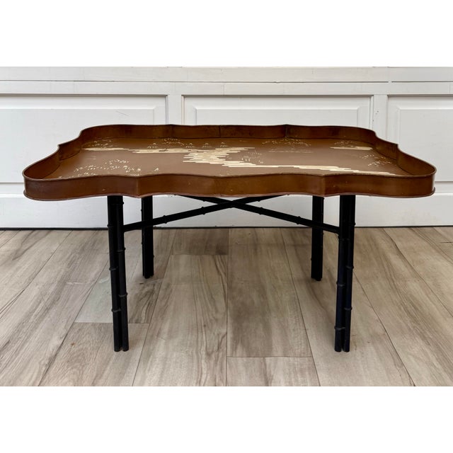 Here is a vintage Italian Chinoiserie tole tray coffee table, featuring a beautifully hand-decorated brown metal tray with...