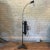 Industrial, machine age, optical, medical floor lamp by Bausch & Lomb features a cast iron base with height adjustable,...