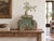 Coral rosettes bloom on a field of soft green. This antique teak capital is the showpiece of the collection, carved in...
