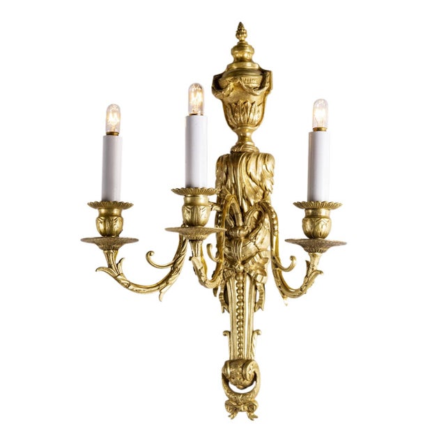 A pair of antique gilded bronze wall sconces, dating back to the last quarter of the 19th century, are fire-gilded Louis...