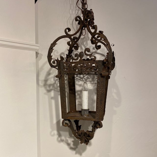 French 4-sided iron lantern with delicate scroll work. Newly rewired with one wax covered electric candle.
