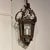 French 4-sided iron lantern with delicate scroll work. Newly rewired with one wax covered electric candle.