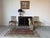 Elegant 1930s Hollywood Regency-style small cabinet featuring a rich ebonized finish accented with giltwood trim. Its...