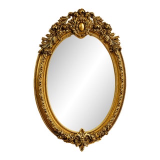 Ornate Gilded Oval Mirror – French-Inspired Frame With Sculpted Bow Detail For Sale