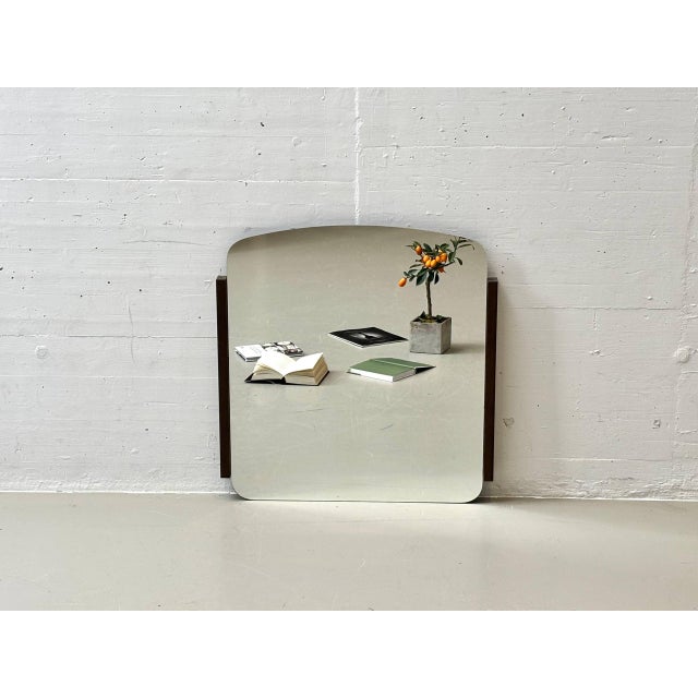 Striking wall mirror with a clean, graphic design reminiscent of the 1970s. The minimalist form and balanced combination...