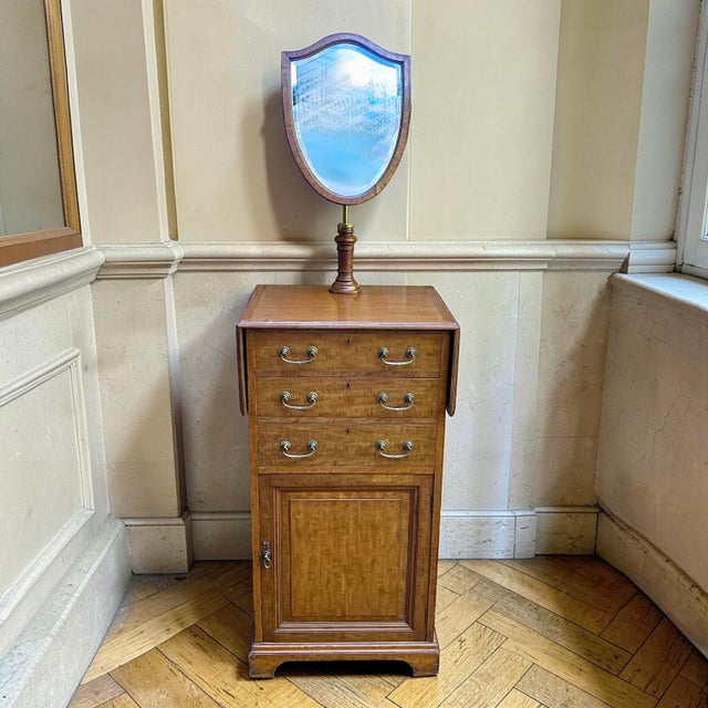 A wonderful and functional Edwardian mahogany dressing chest with an adjustable shield‑shaped mirror. The bevel‑edged...