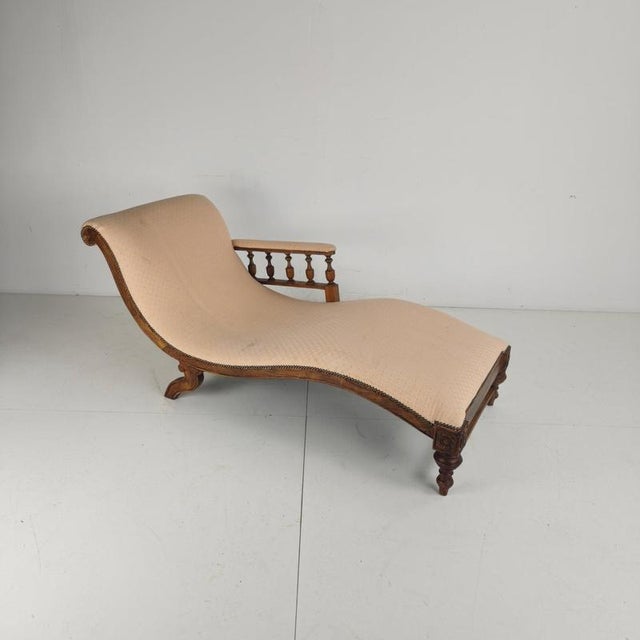 Elegant late 19th century English chaise longue with a beautifully shaped solid wood frame and finely carved detailing....