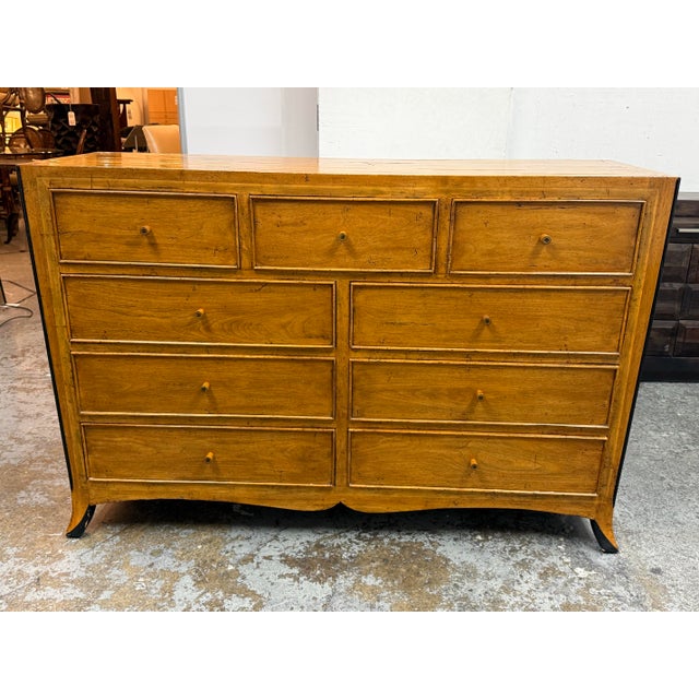 Design Plus Gallery presents a Nine-Drawer Dresser from Bausman & Company. This dresser showcases a mitered plank top with...