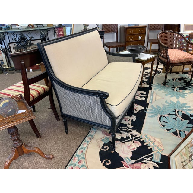 Louis XVI style settee with black painted frame. upholstered with solid beige and houndstooth fabric. Fixed back cushion,...