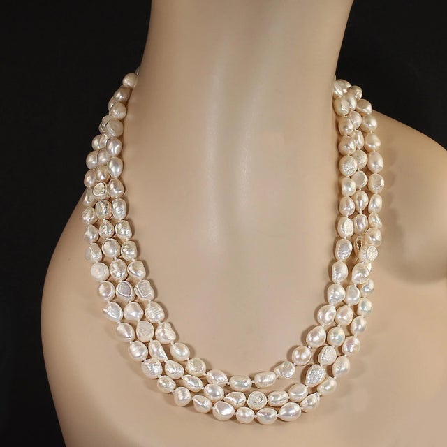 Elevate your elegance with this stunning Infinity necklace, featuring luminous white freshwater cultured pearls ranging...
