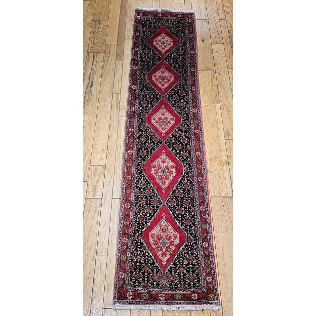 "Beautiful late 20th century Persian Bidjar runner. This captivating runner features a deep navy blue background color...