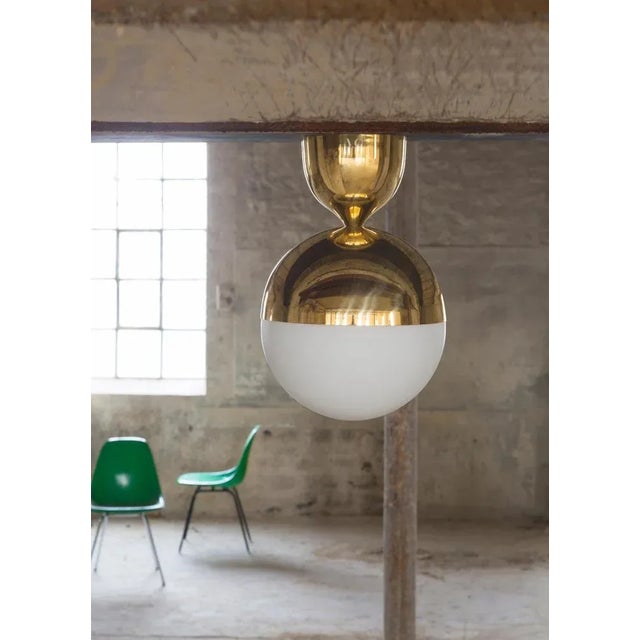 Brass ceiling lamp by magic circus editions dimensions: d 25 x w 25 x h 37.5 cm materials: brass, mouth blown glass...