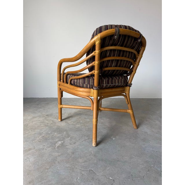 Elegant vintage accent -dining chair by Brown Jordan, crafted in warm honey-toned rattan with their signature sculptural...